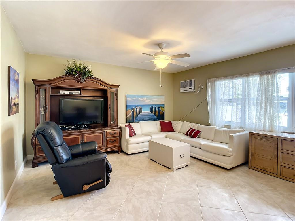 3208 Colony Club Road, Unit 2 Pompano Beach, FL 33062 - Photo 7 of 26 a living room with furniture and a flat screen tv