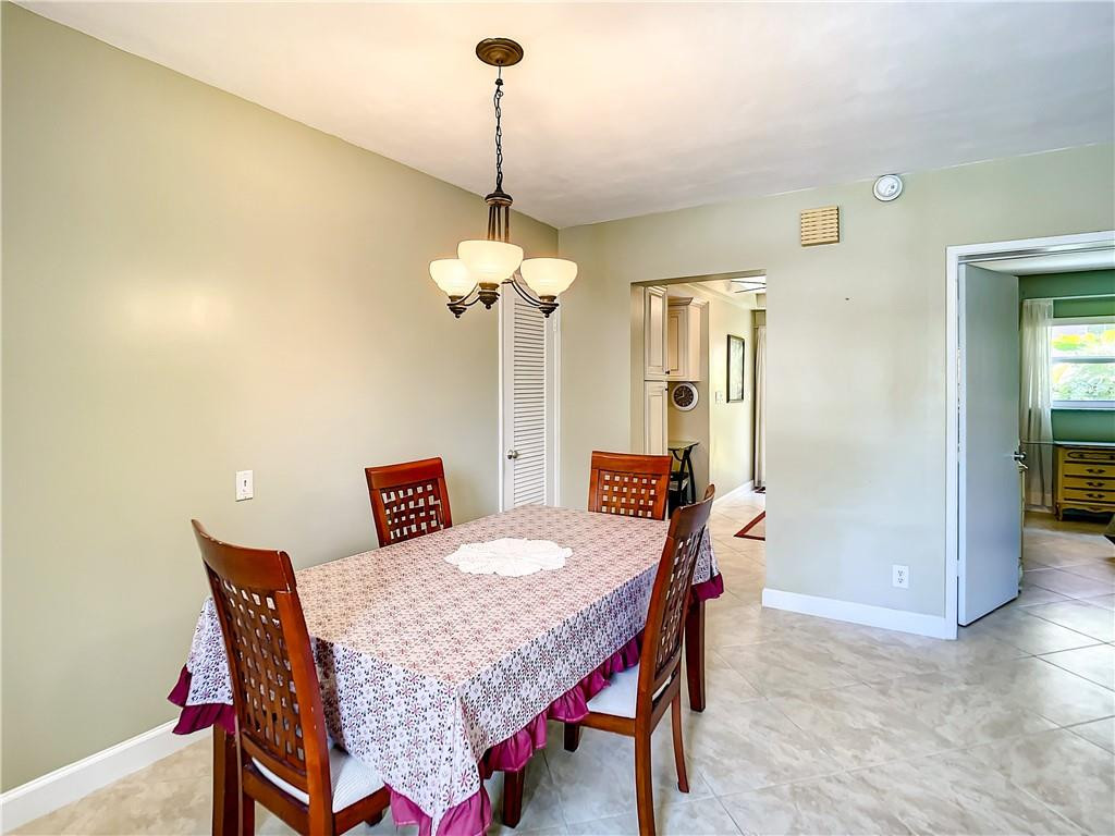3208 Colony Club Road, Unit 2 Pompano Beach, FL 33062 - Photo 8 of 26 a view of a dining room with a table and chairs