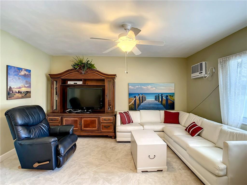 3208 Colony Club Road, Unit 2 Pompano Beach, FL 33062 - Photo 9 of 26 a living room with furniture and a flat screen tv