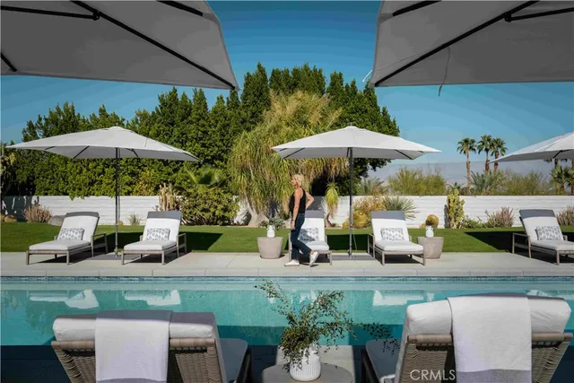 a view of a table and chairs under an umbrella