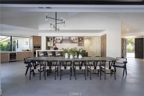 a kitchen with a table chairs sink and cabinets