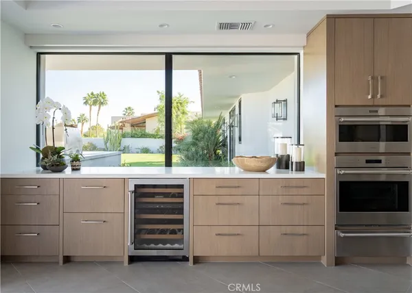 a kitchen with lots of bottles of alcohol