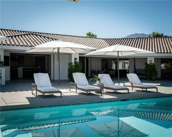 a view of a patio with a table chairs and a backyard