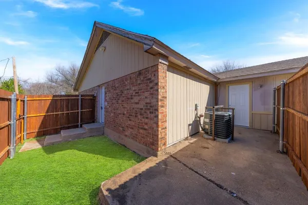 a view of a backyard with furniture and a garage