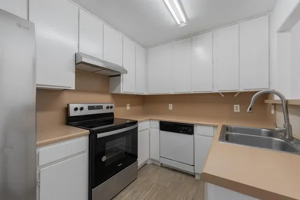 a kitchen with a sink and a stove top oven