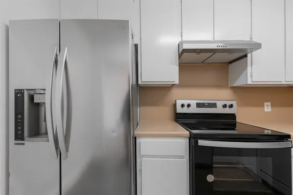 a kitchen with a stove and a refrigerator