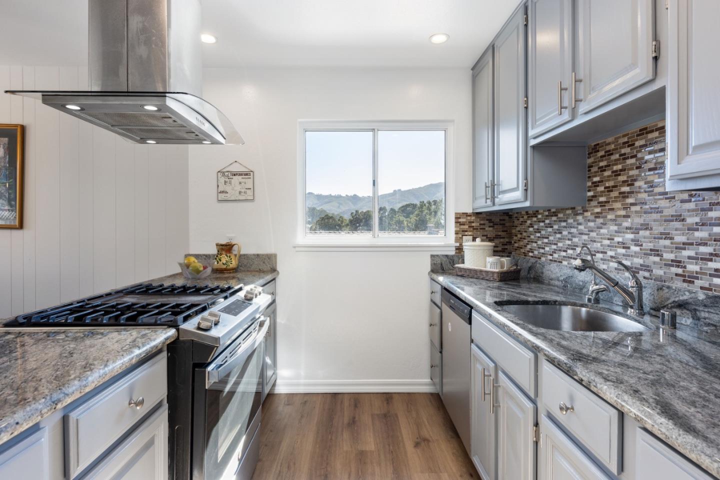 1155 Banyan Way Pacifica, CA 94044 - Photo 13 of 45 a kitchen with granite countertop a sink stove and cabinets