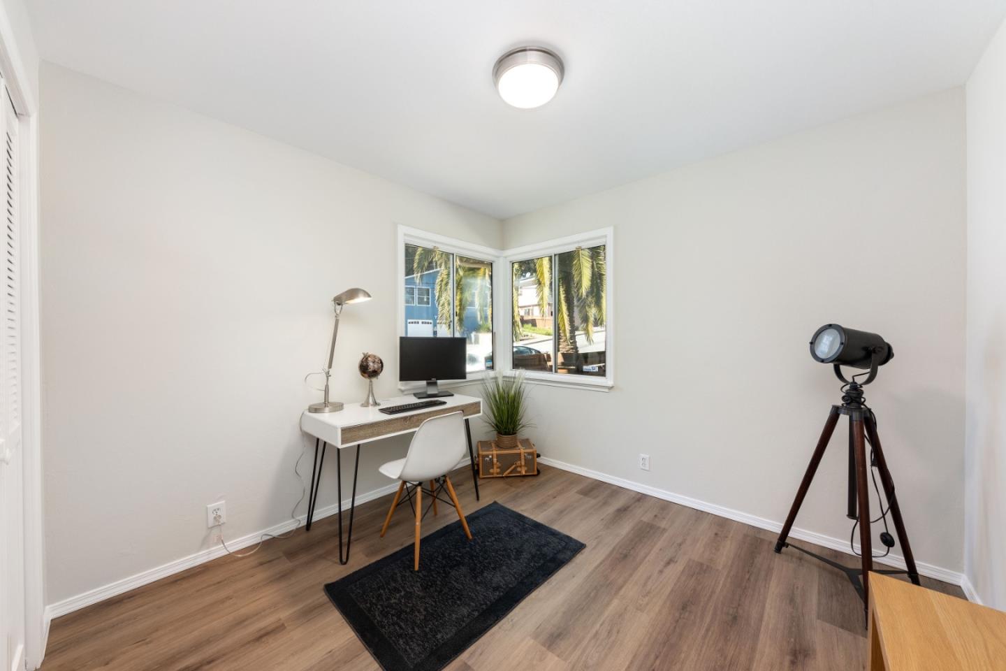 1155 Banyan Way Pacifica, CA 94044 - Photo 24 of 45 a view of a workspace with furniture and wooden floor