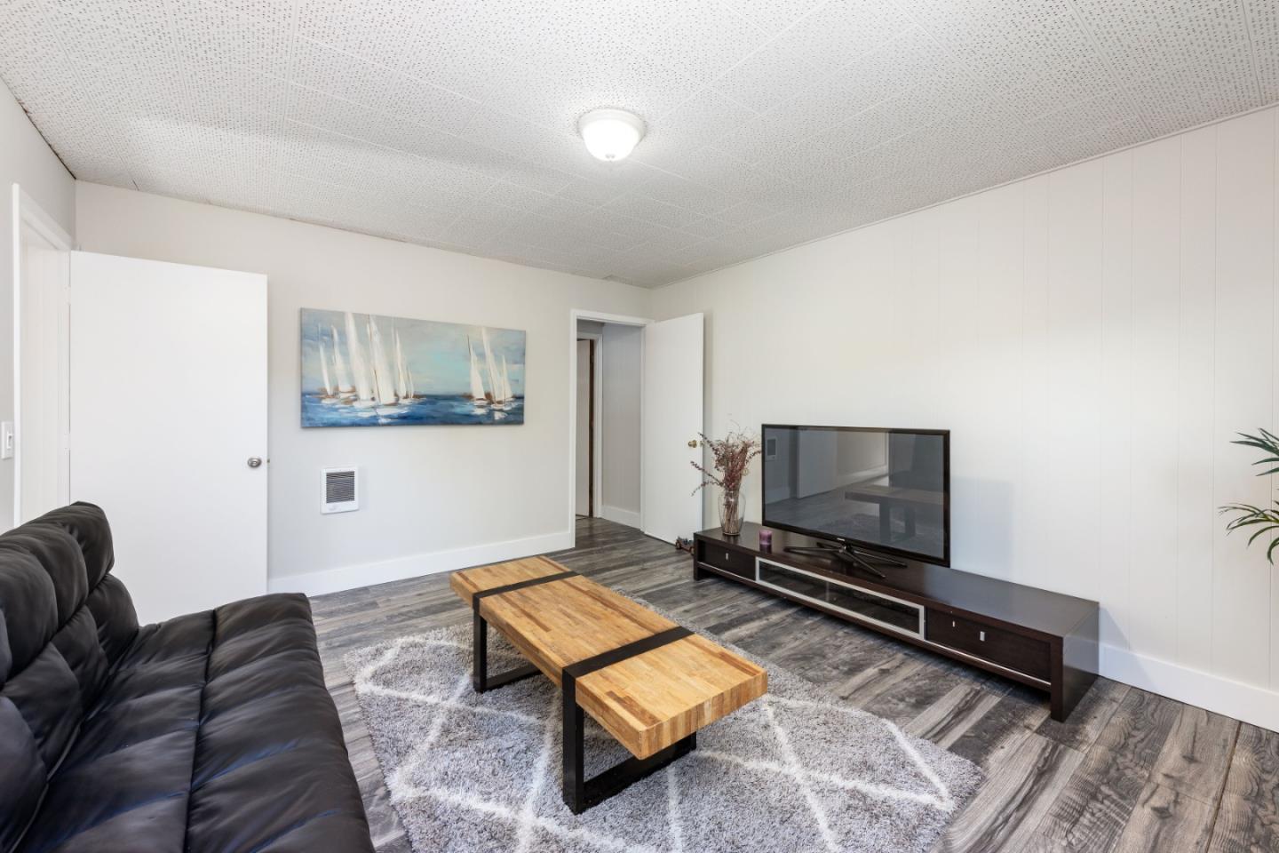 1155 Banyan Way Pacifica, CA 94044 - Photo 29 of 45 a living room with furniture a flat screen tv and a window