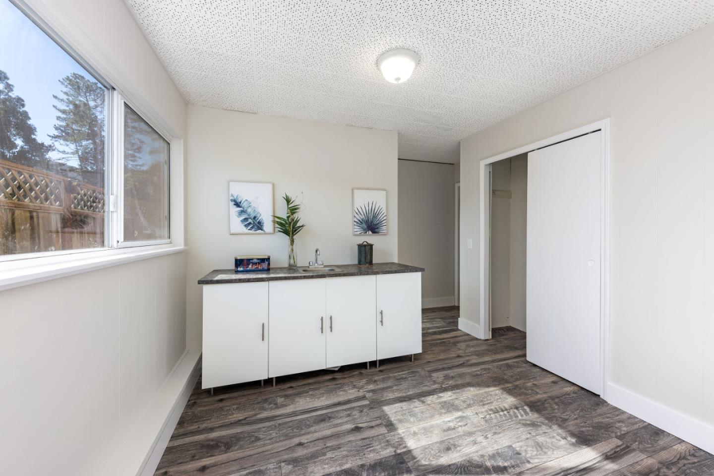 1155 Banyan Way Pacifica, CA 94044 - Photo 31 of 45 a room with painting on the wall and a window