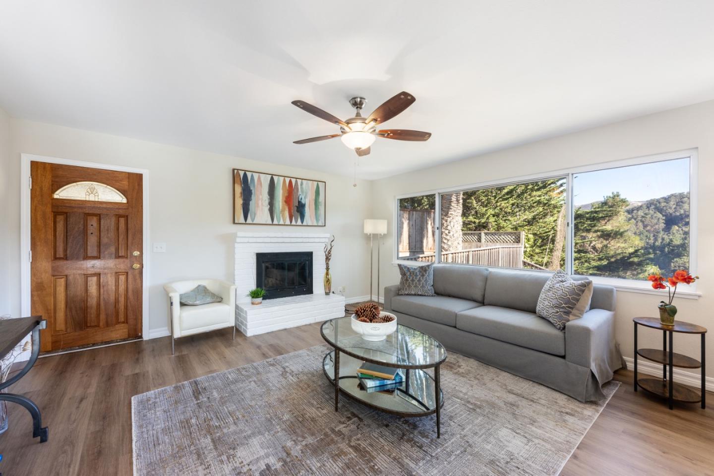 1155 Banyan Way Pacifica, CA 94044 - Photo 4 of 45 a living room with furniture a fireplace and a large window
