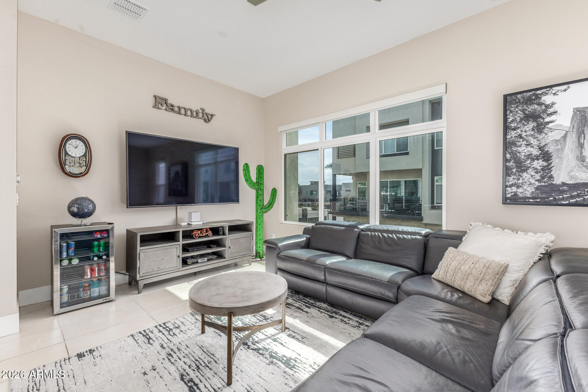 6850 East McDowell Road, Unit 71 Scottsdale, AZ 85257 - Photo 2 of 36 a living room with furniture and a flat screen tv
