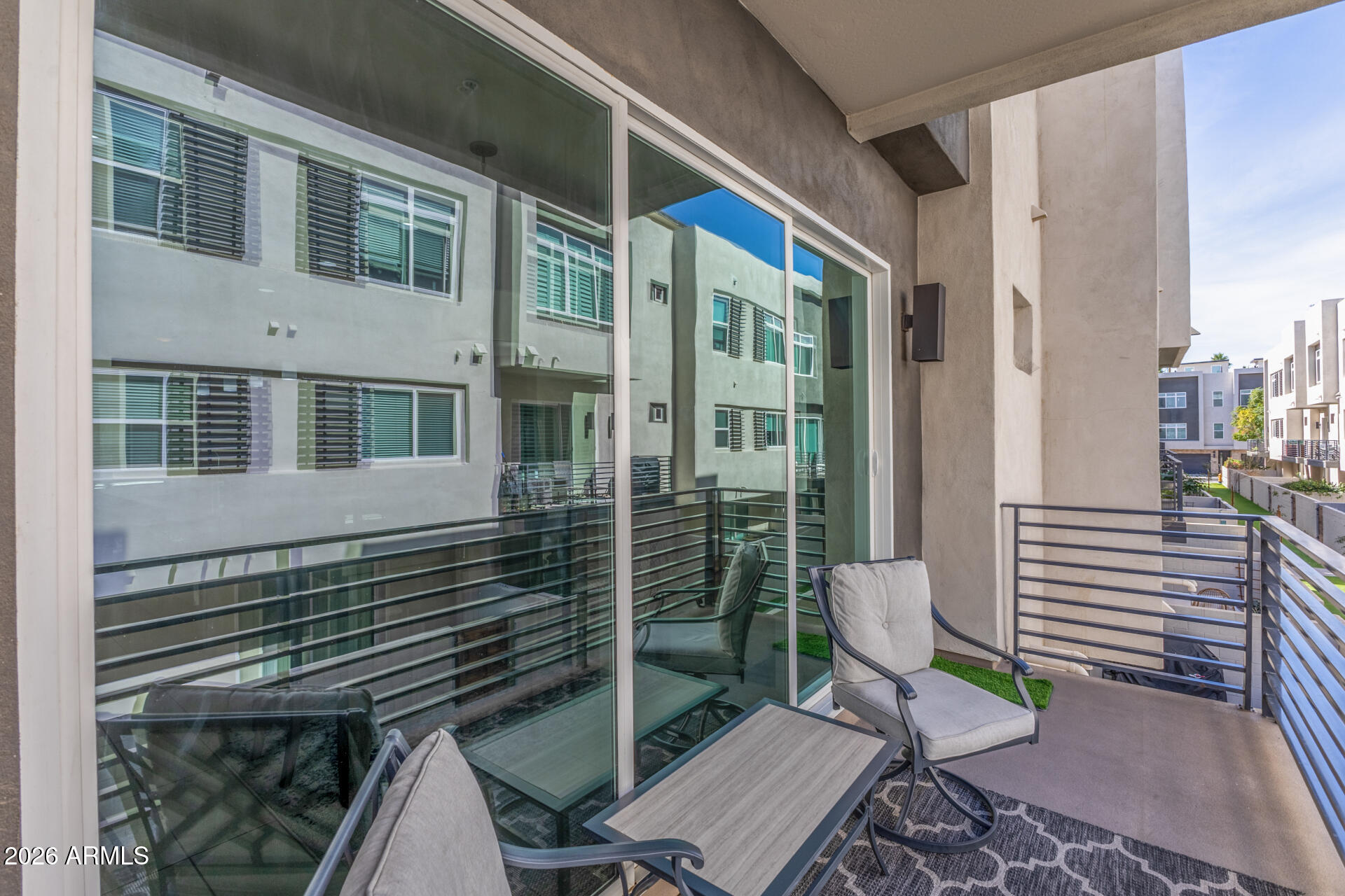 6850 East McDowell Road, Unit 71 Scottsdale, AZ 85257 - Photo 28 of 36 a view of a patio with table and chairs and wooden floor