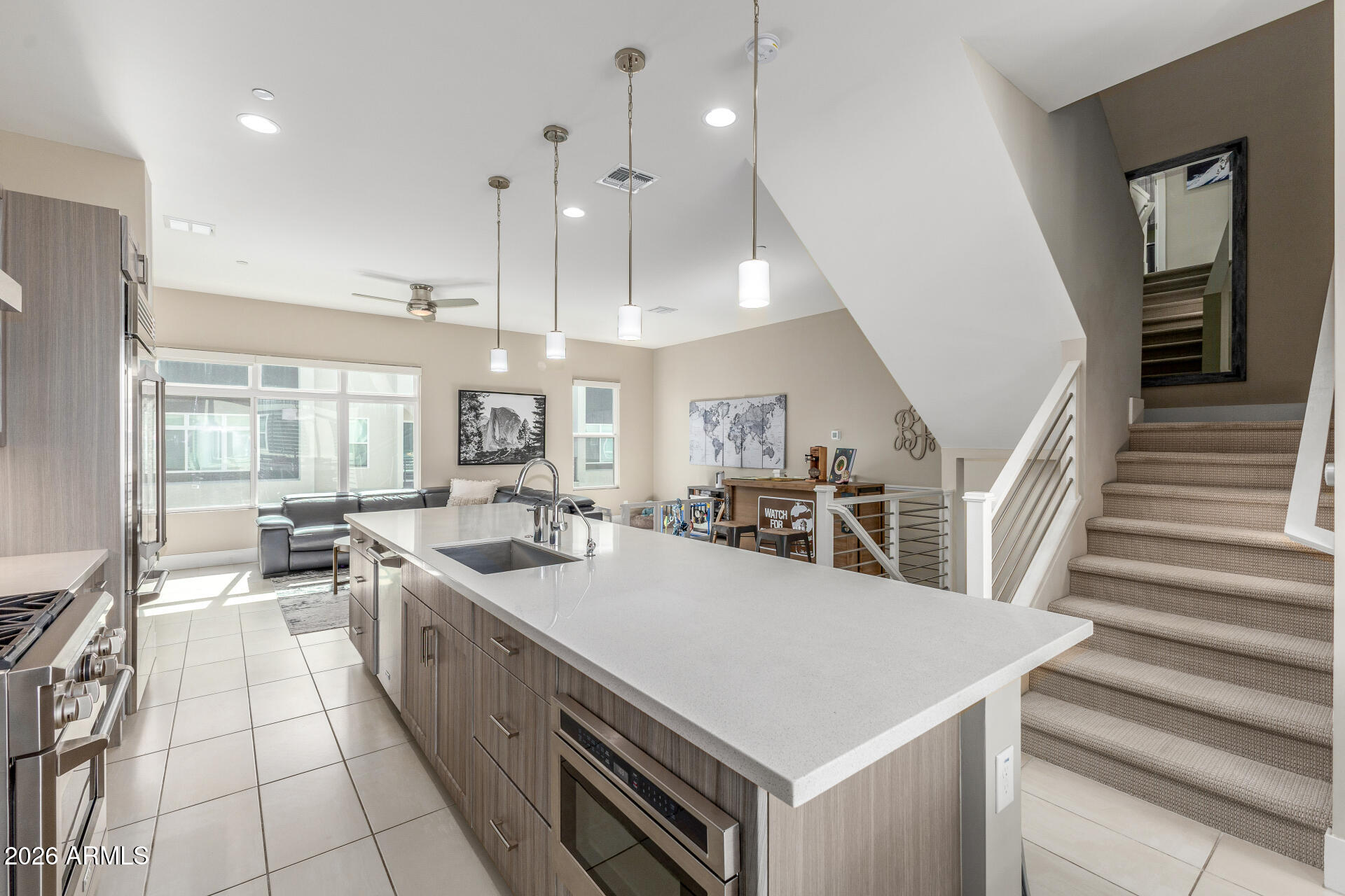 6850 East McDowell Road, Unit 71 Scottsdale, AZ 85257 - Photo 5 of 36 a kitchen with stainless steel appliances granite countertop a sink a stove and a refrigerator