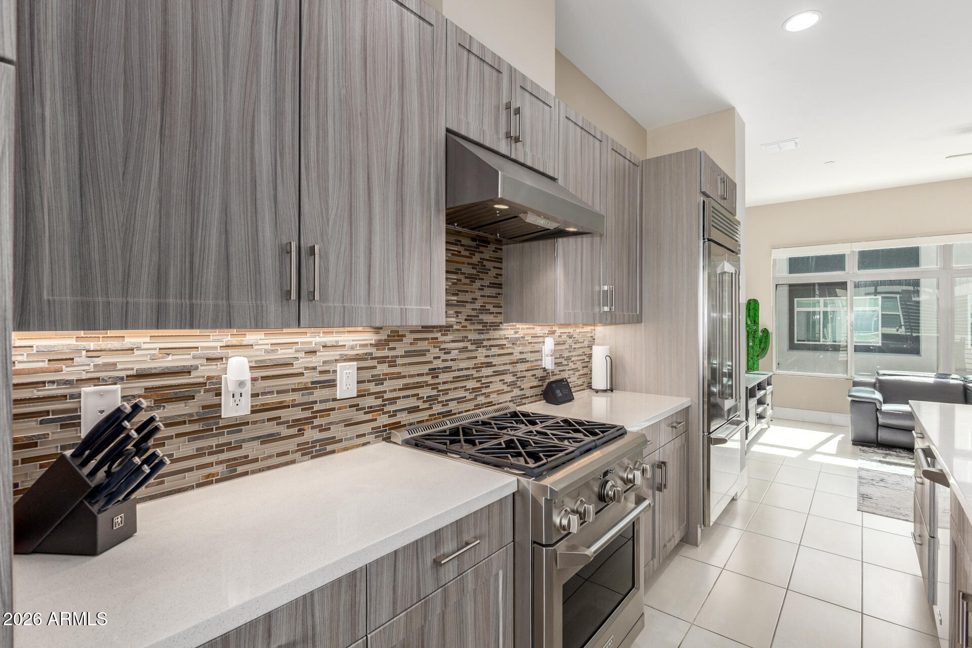 6850 East McDowell Road, Unit 71 Scottsdale, AZ 85257 - Photo 6 of 36 a kitchen with a stove a sink and a wooden cabinets