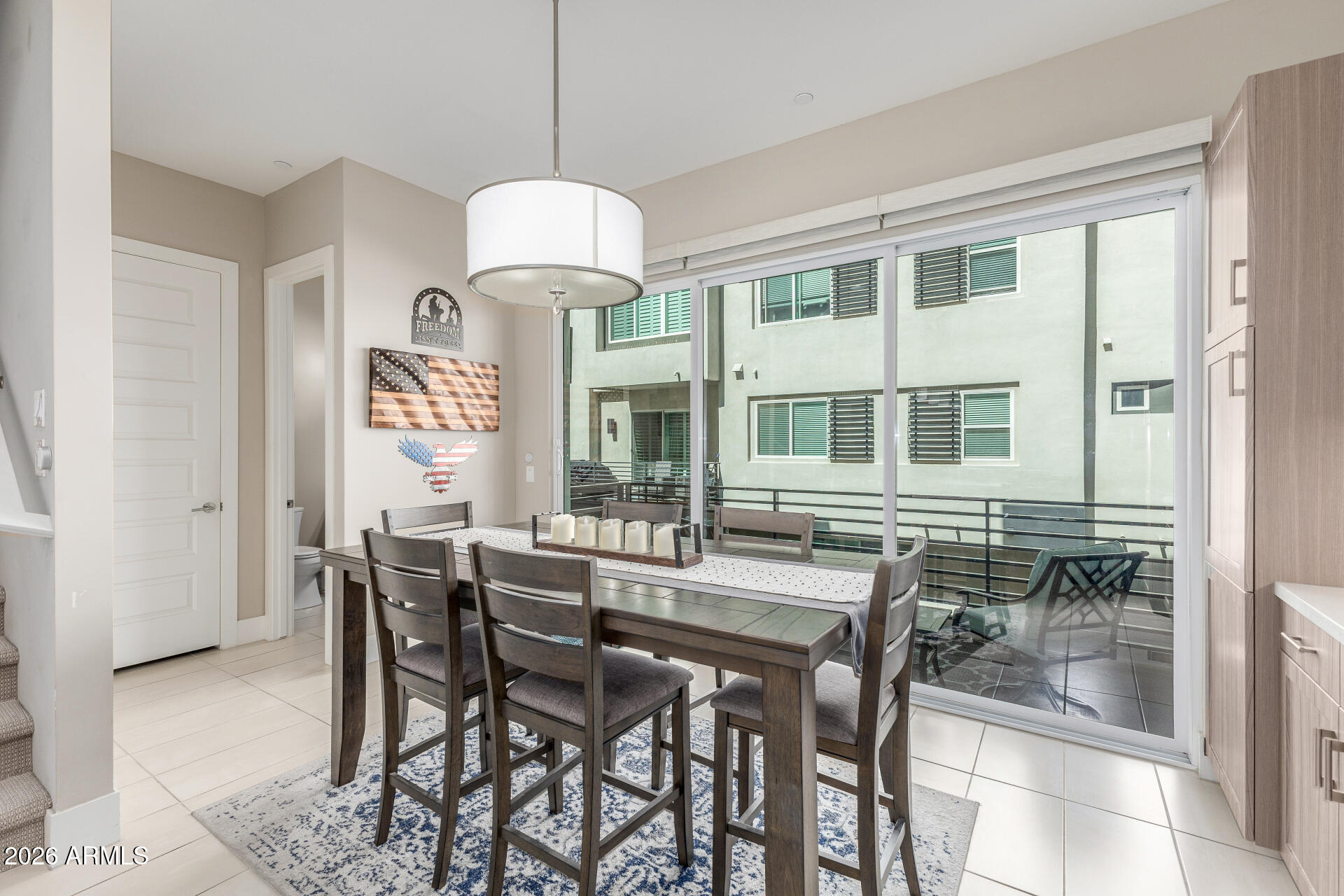6850 East McDowell Road, Unit 71 Scottsdale, AZ 85257 - Photo 10 of 36 a view of a dining room with furniture and chandelier