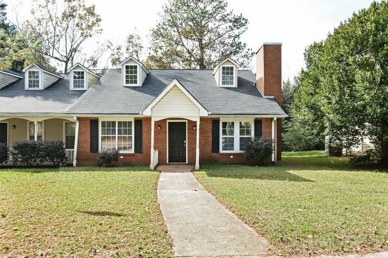 Undisclosed Address Conyers, GA 30013 - Photo 1 of 24 a front view of a house with a yard and trees