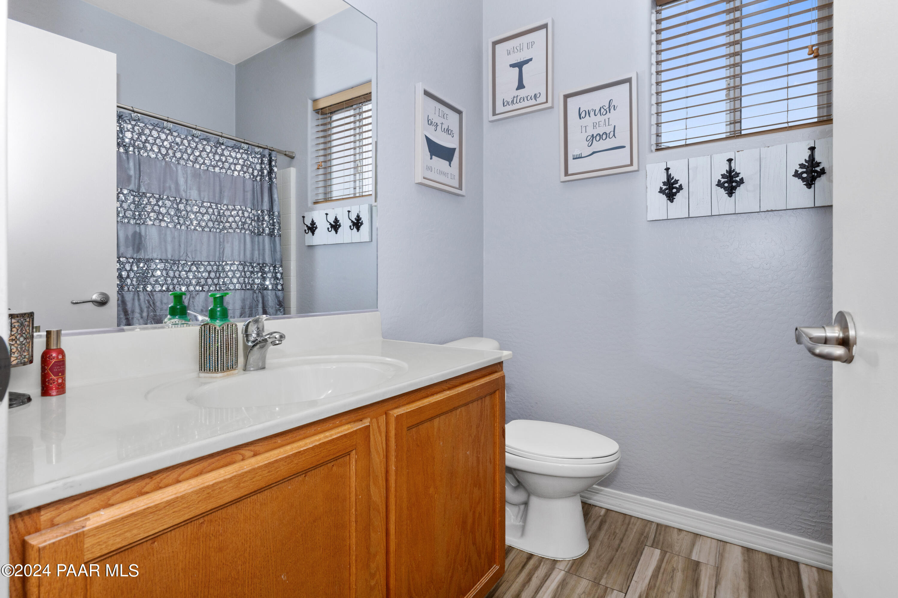 7753 Melody Ranch Road Prescott Valley, AZ 86315 - Photo 17 of 42 a bathroom with a granite countertop sink toilet and a mirror