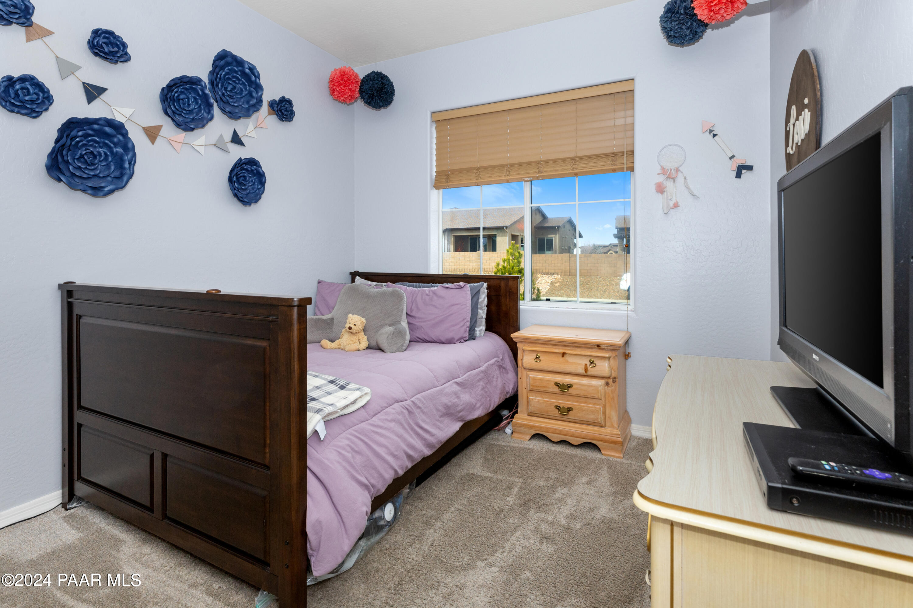 7753 Melody Ranch Road Prescott Valley, AZ 86315 - Photo 18 of 42 a bedroom with a bed and a flat tv screen on the dresser