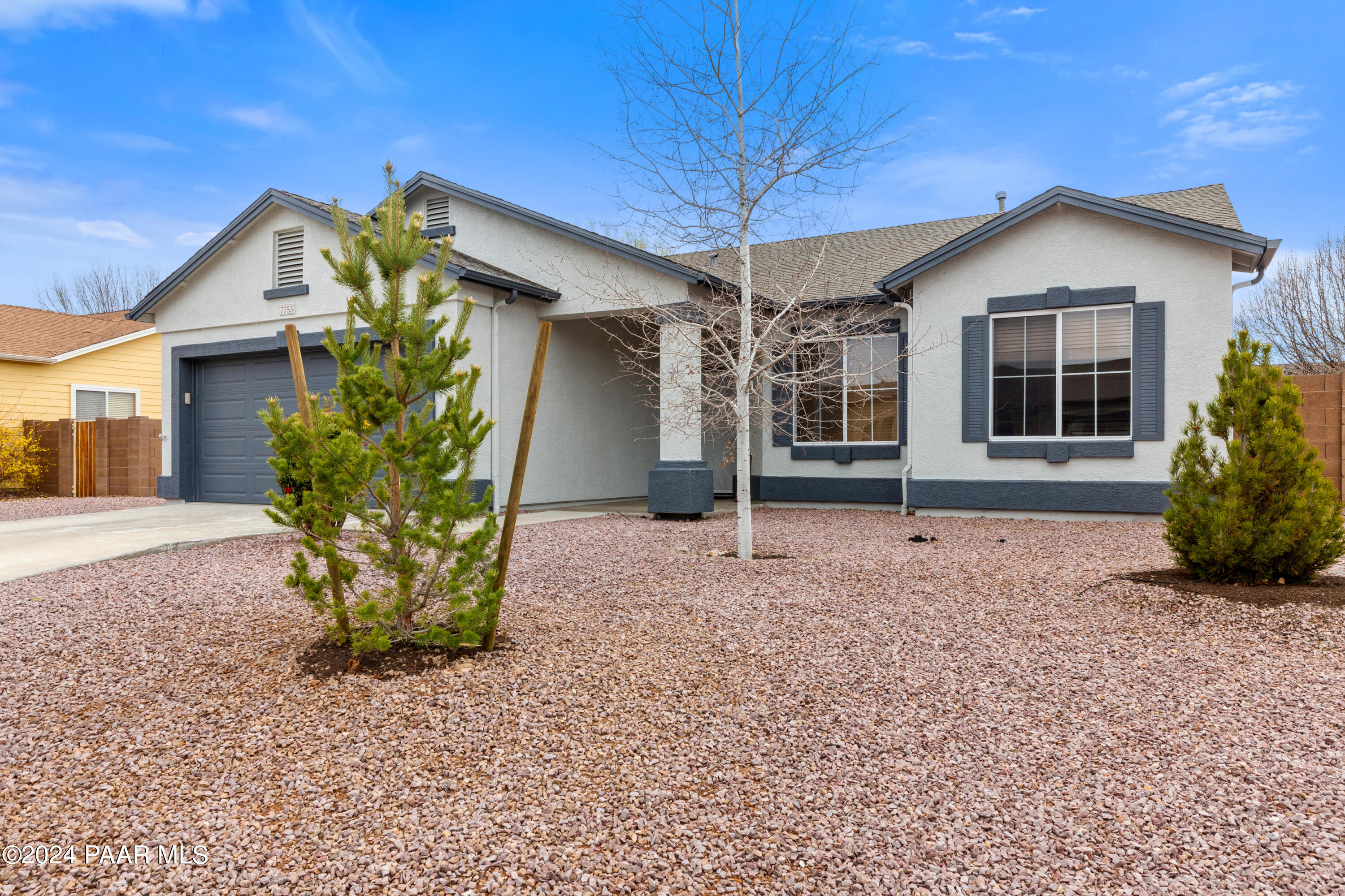 7753 Melody Ranch Road Prescott Valley, AZ 86315 - Photo 2 of 42 a front view of a house with garden