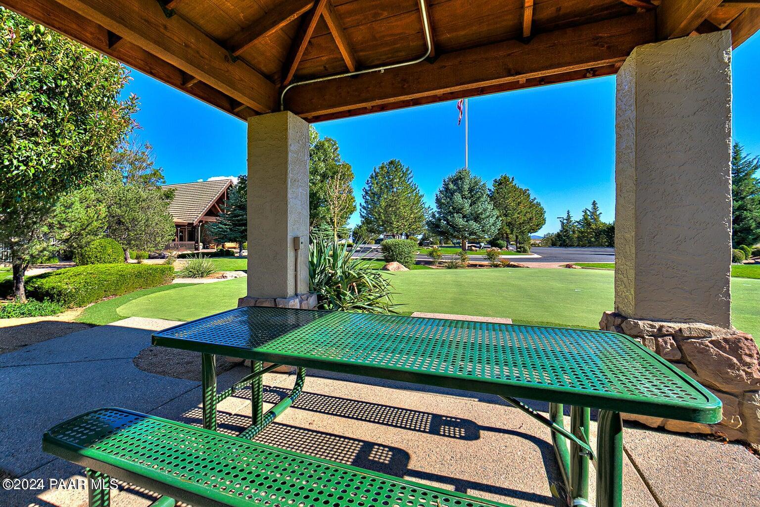 7753 Melody Ranch Road Prescott Valley, AZ 86315 - Photo 38 of 42 a view of a chairs and table in patio with a yard