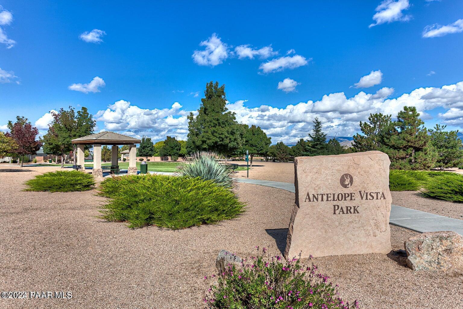 7753 Melody Ranch Road Prescott Valley, AZ 86315 - Photo 40 of 42 a front view of a house with a garden