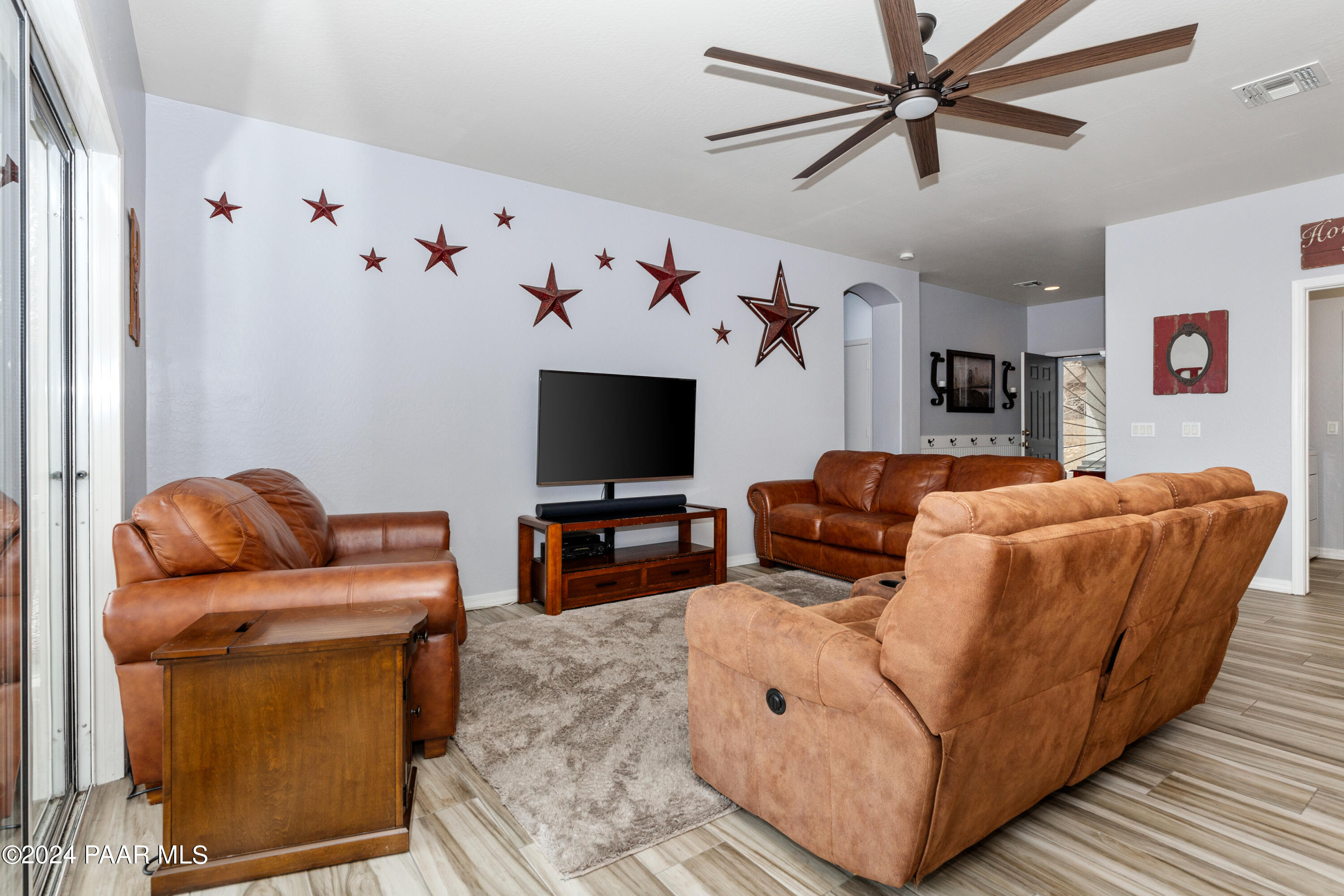 7753 Melody Ranch Road Prescott Valley, AZ 86315 - Photo 4 of 42 a living room with furniture and a flat screen tv