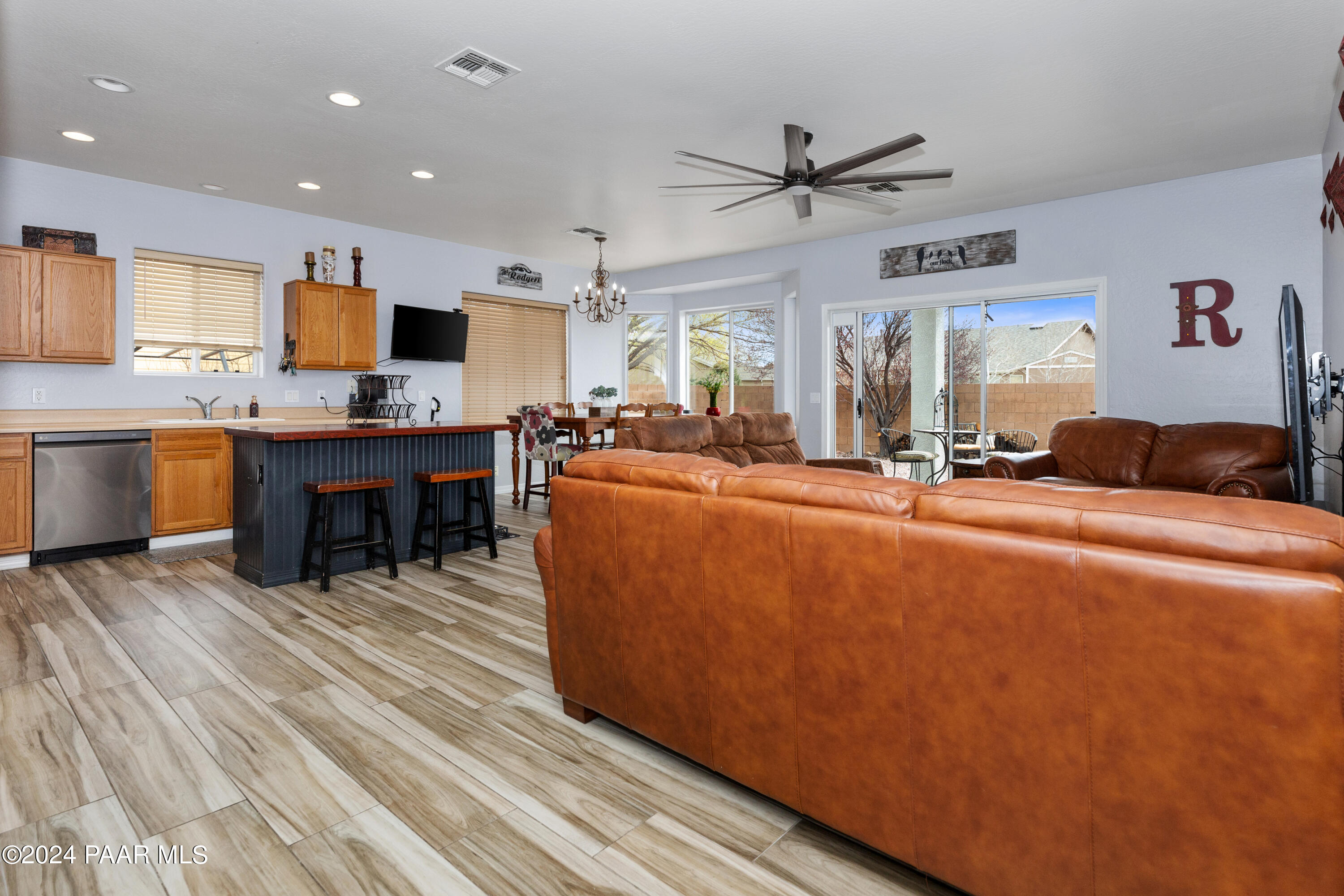 7753 Melody Ranch Road Prescott Valley, AZ 86315 - Photo 5 of 42 a living room with furniture a dining table and a fireplace