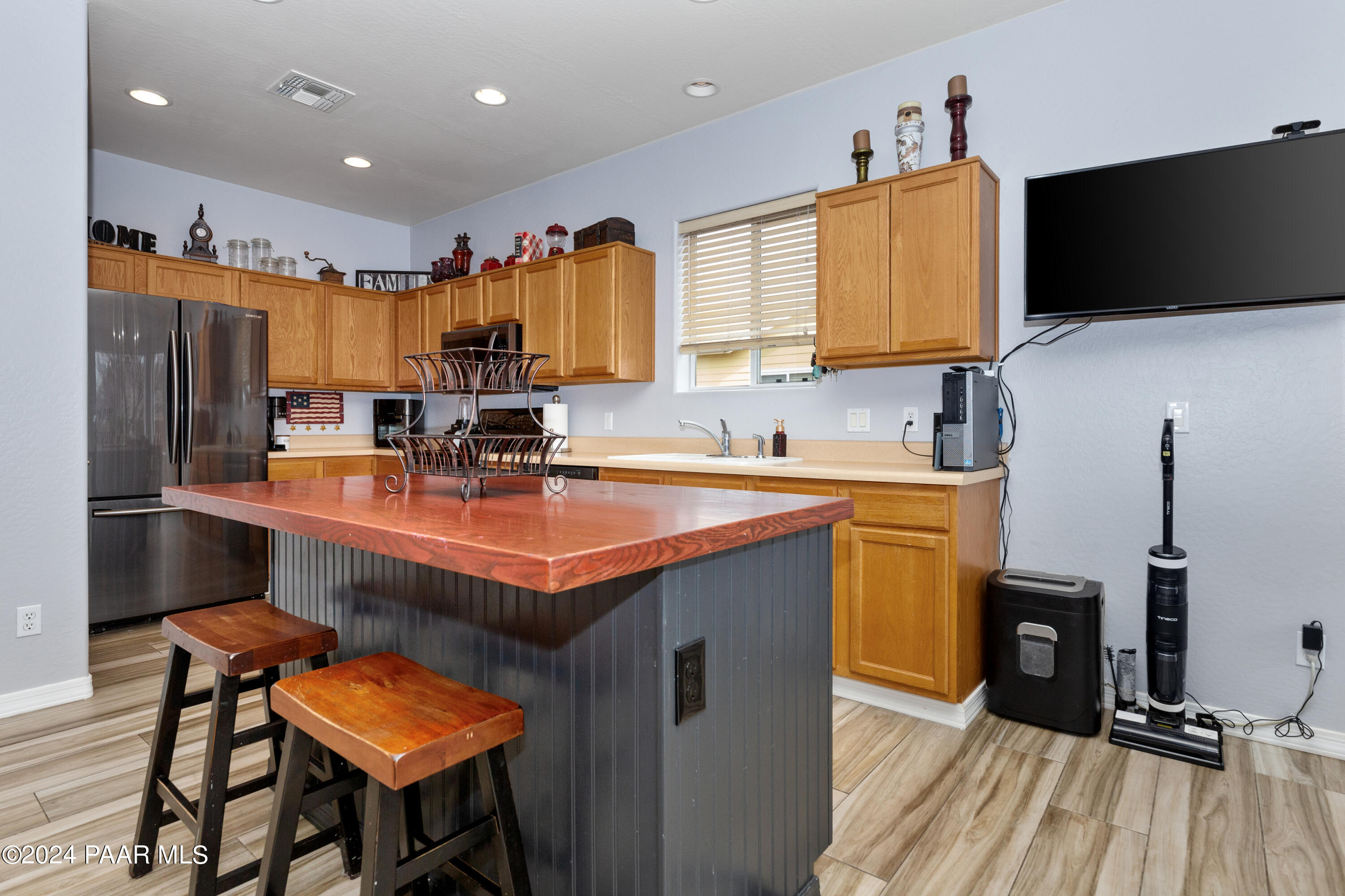 7753 Melody Ranch Road Prescott Valley, AZ 86315 - Photo 6 of 42 a kitchen with stainless steel appliances granite countertop a sink a stove and a refrigerator