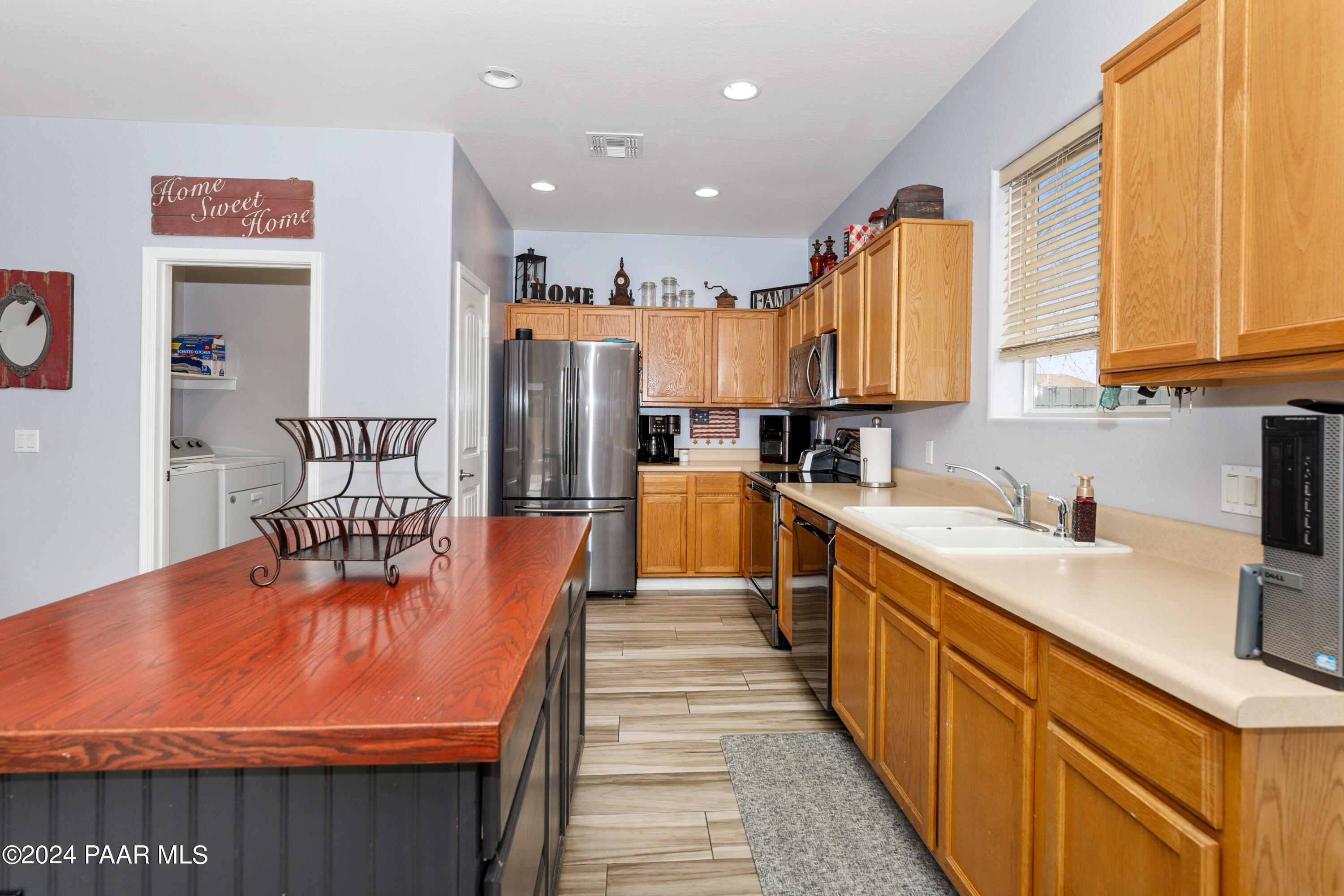 7753 Melody Ranch Road Prescott Valley, AZ 86315 - Photo 7 of 42 a kitchen with stainless steel appliances kitchen island granite countertop a sink and cabinets