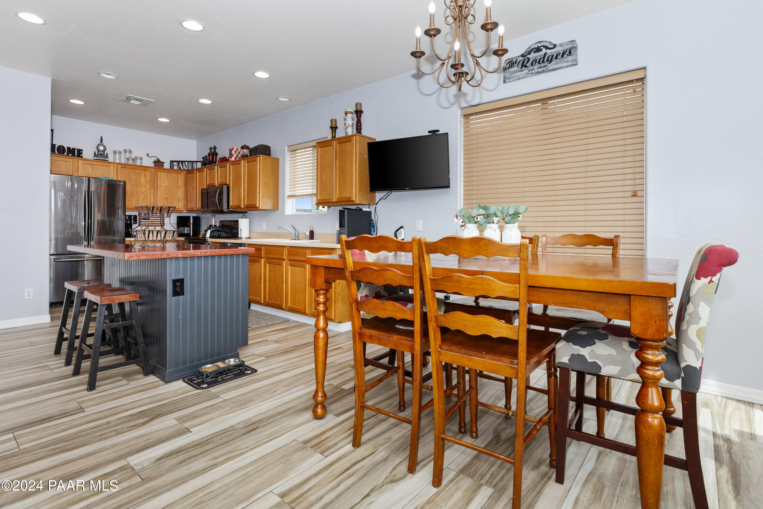 7753 Melody Ranch Road Prescott Valley, AZ 86315 - Photo 8 of 42 a kitchen with stainless steel appliances kitchen island granite countertop a table and chairs in it