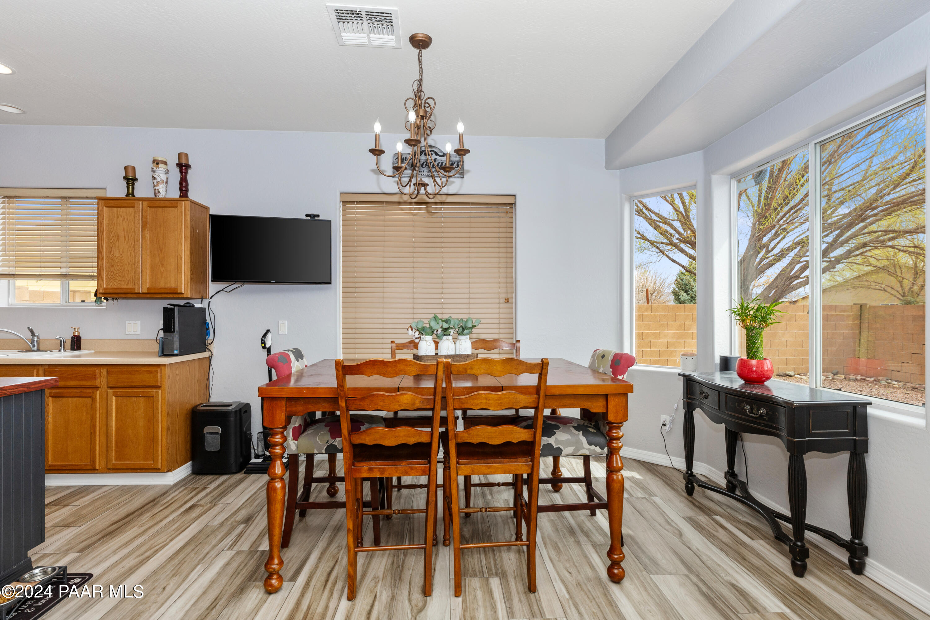 7753 Melody Ranch Road Prescott Valley, AZ 86315 - Photo 9 of 42 a view of a dining room with furniture and a chandelier