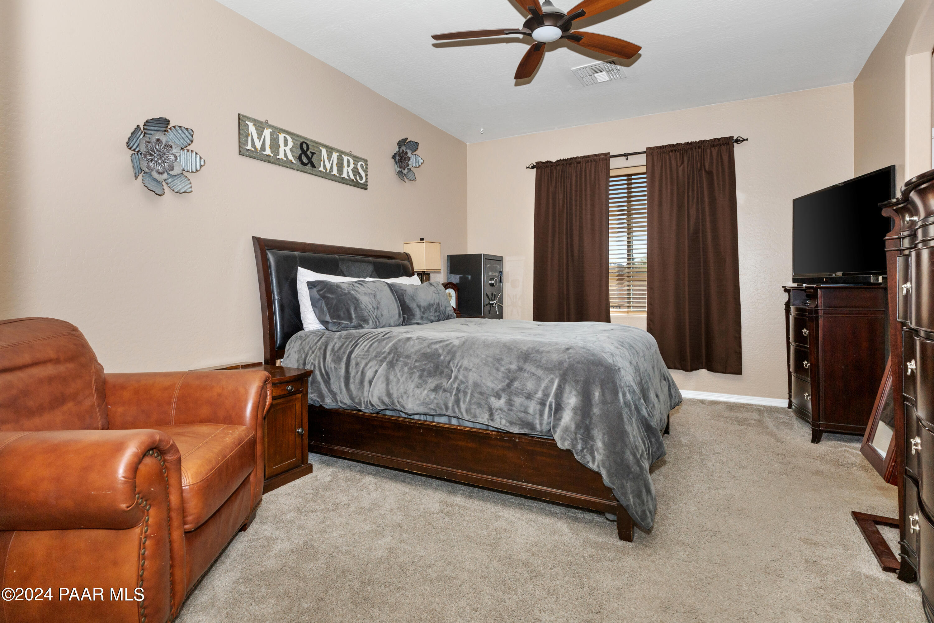 7753 Melody Ranch Road Prescott Valley, AZ 86315 - Photo 10 of 42 a bedroom with a bed and a flat screen tv