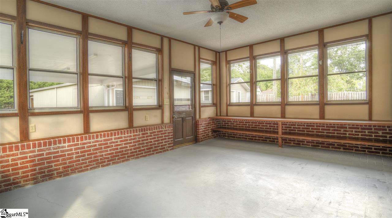 2305 East Lee Road Taylors, SC 29687 - Photo 17 of 27 The sunroom overlooking the pool, patio and/or warehouses … built in shelving for your succulents.