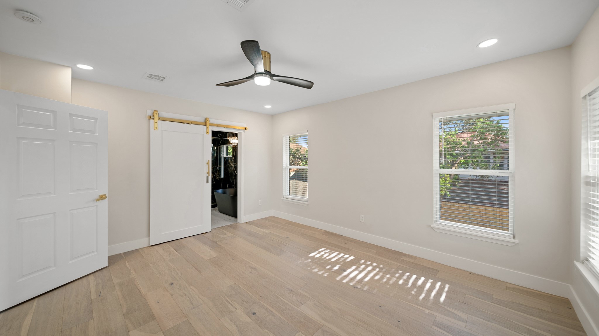 2119 Isabella Street Houston, TX 77004 - Photo 16 of 23 a view of an empty room with a window and wooden floor