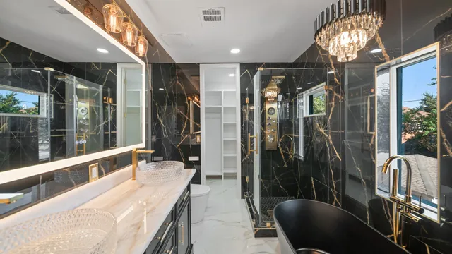 a bathroom with double vanity and a shower