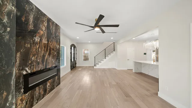 a view of entryway and hall with wooden floor