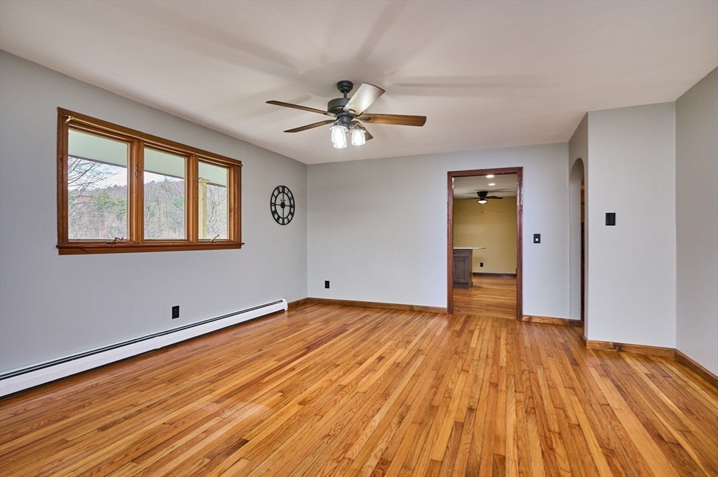 14 East Hawley Road Charlemont, MA 01339 - Photo 9 of 42 a view of empty room with wooden floor and fan