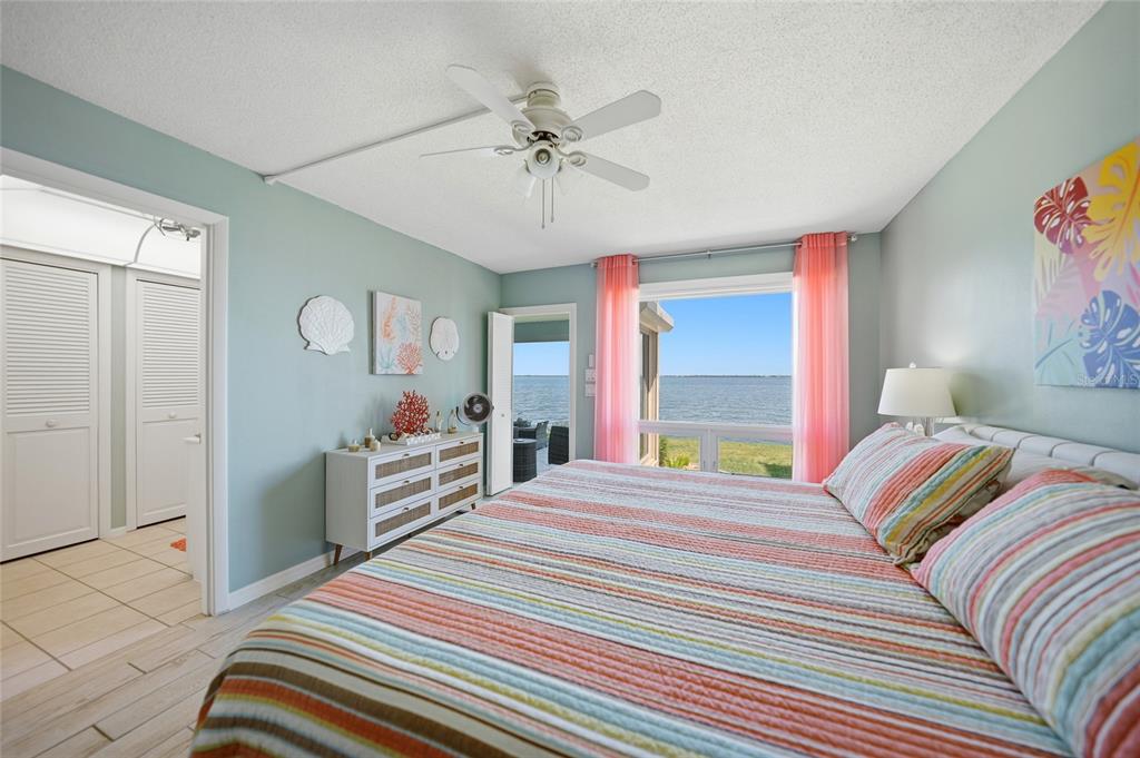 1 Colony Point Drive, Unit A10 Punta Gorda, FL 33950 - Photo 16 of 31 a bedroom with a bed and a chandelier