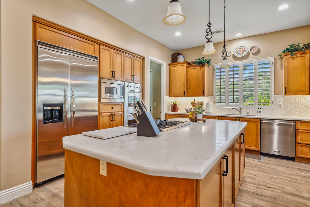35202 Vista Del Monte Rancho Mirage, CA 92270 - Photo 15 of 35 a kitchen with stainless steel appliances granite countertop a sink a stove and a refrigerator