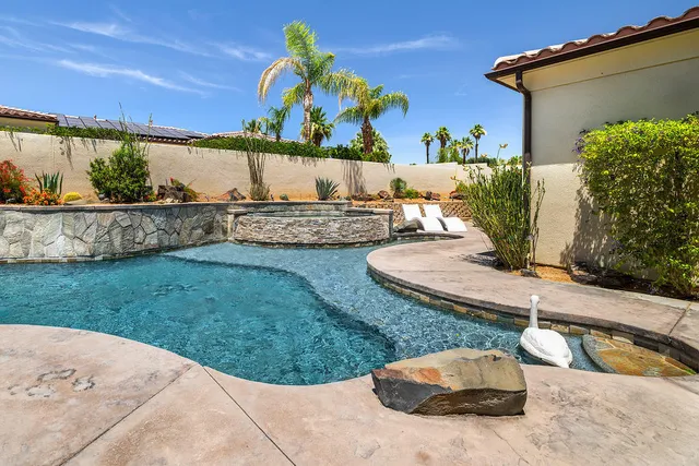 a view of a backyard with plants and outdoor seating