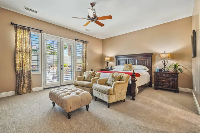 a spacious bedroom with a bed couch and a large window