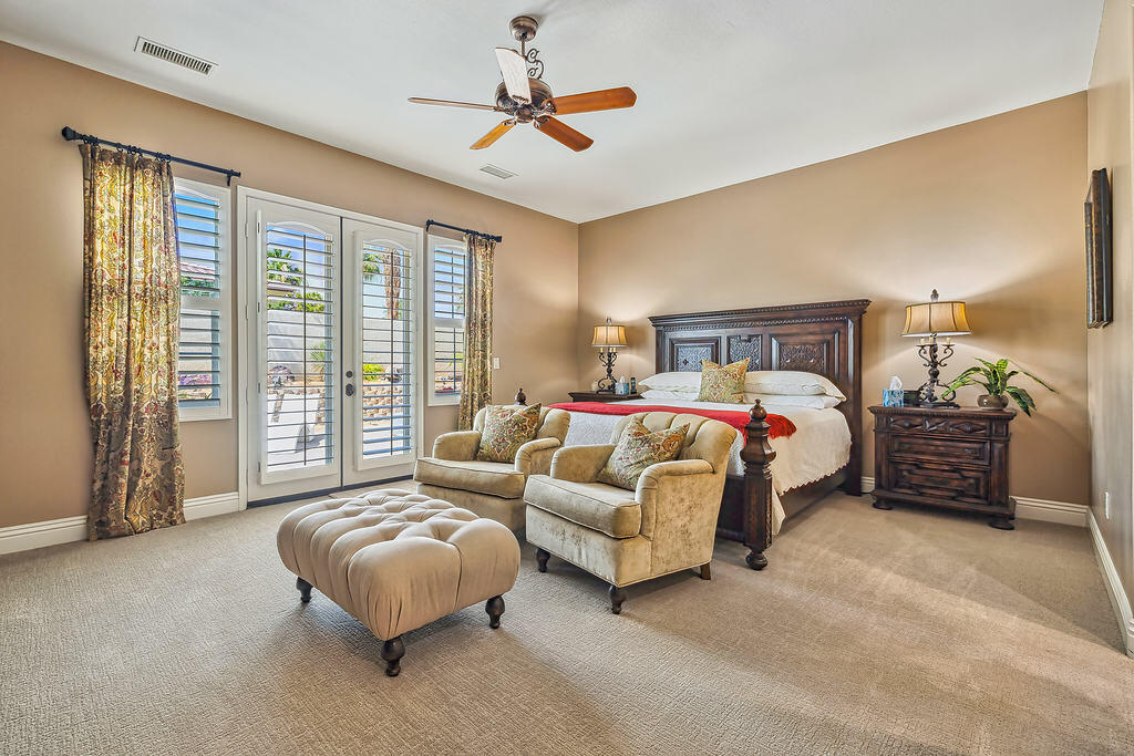 35202 Vista Del Monte Rancho Mirage, CA 92270 - Photo 4 of 35 a spacious bedroom with a bed couch and a large window