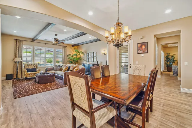 a view of a dining room with furniture wooden floor and chandelier