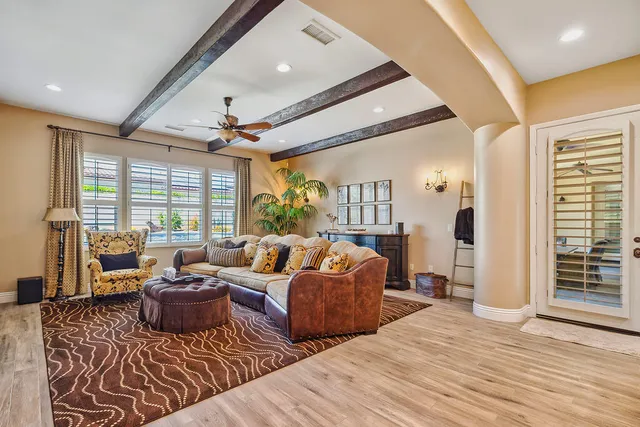 a dining room filled chandelier and wooden floor