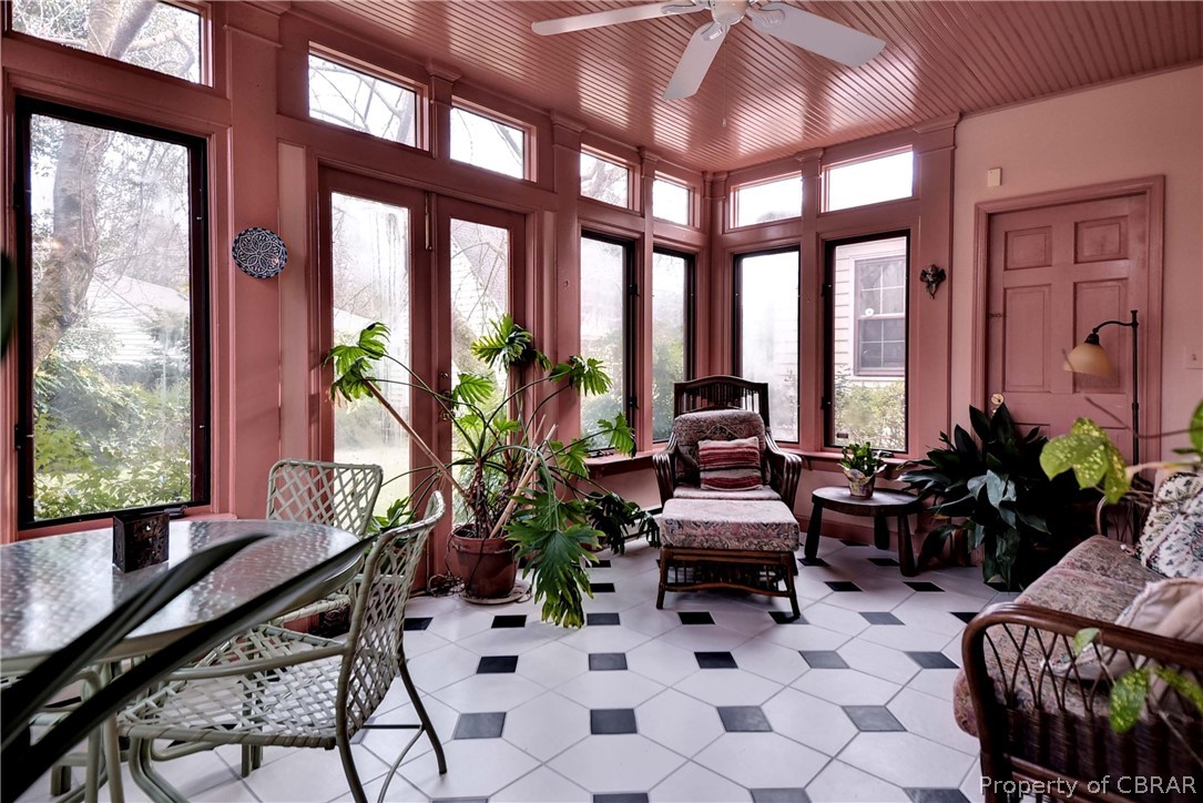 301 Indian Springs Road Williamsburg, VA 23185 - Photo 7 of 25 The light-filled sunroom with beadboard ceiling and black and white tiled flooring overlooks the private backyard.