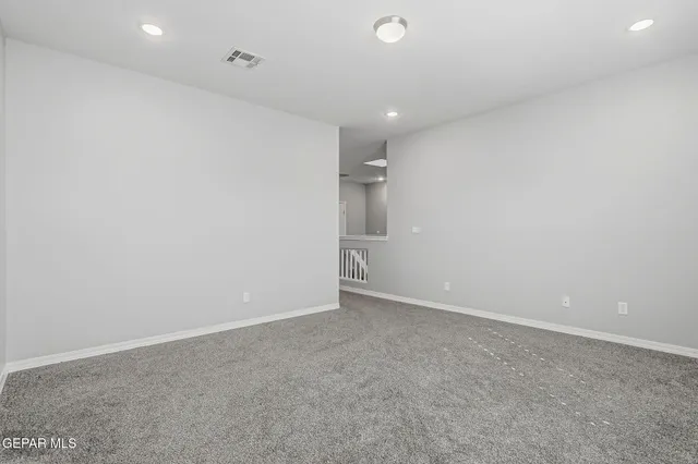 an empty room with an entryway and an empty space