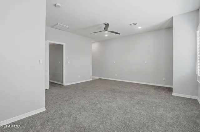 a bathroom with a granite countertop sink a toilet a mirror and shower