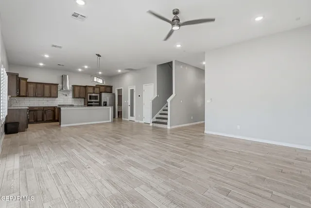 a view of a kitchen with a sink and a refrigerator
