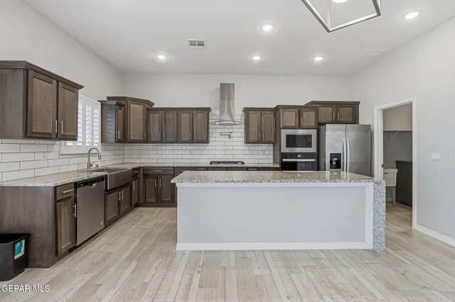 a large kitchen with stainless steel appliances